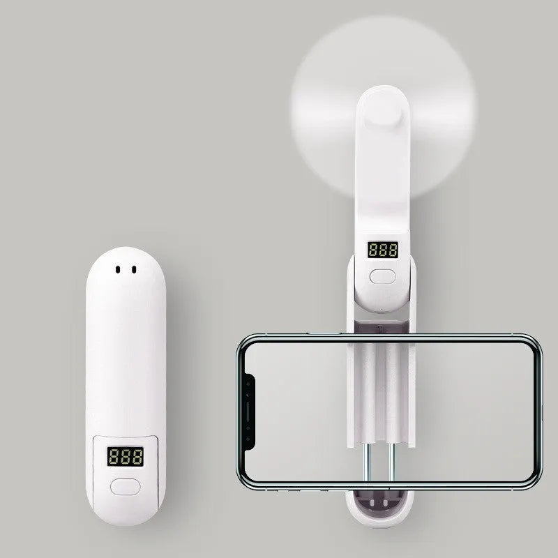 Green folding mini USB fan with plastic blades on a white background.