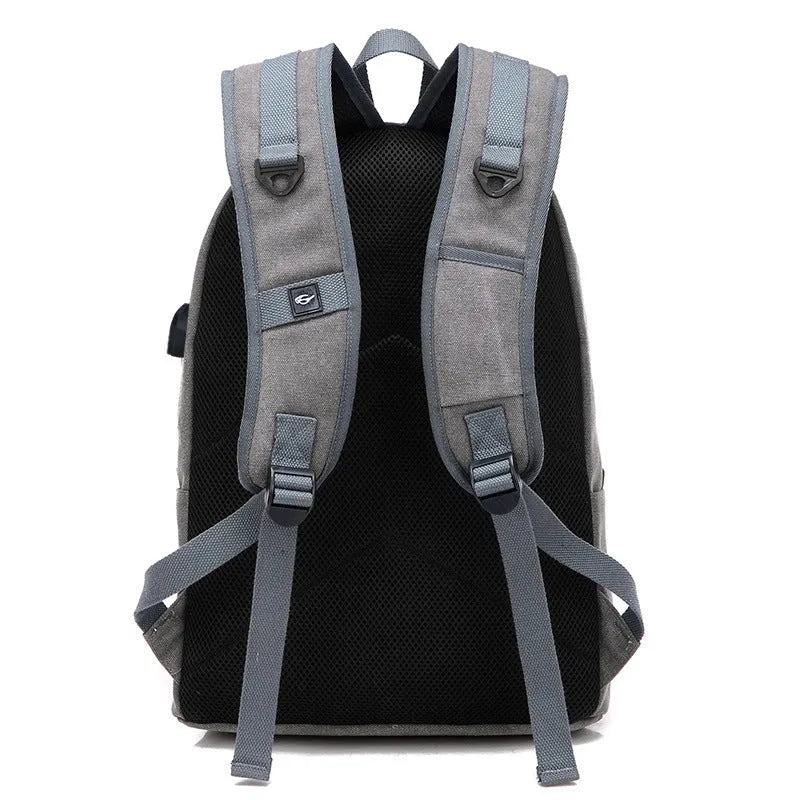 Canvas USB charging backpack in khaki colour showing front compartment and USB port.