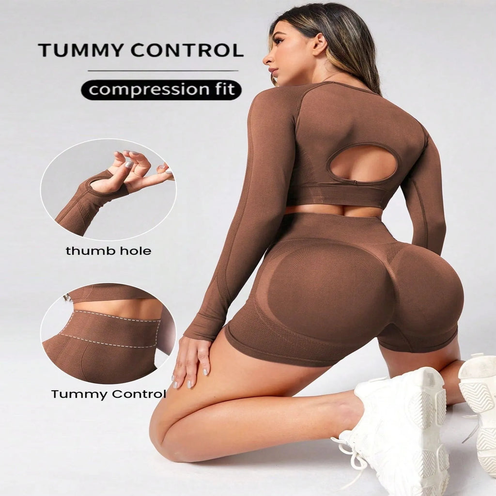 Women's black high-waist yoga suit with long sleeve top and tight-fit pants laid flat.