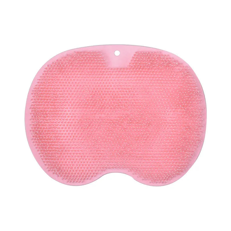 Orange silicone bristle massage bath brush with suction cup bottom on bathroom floor