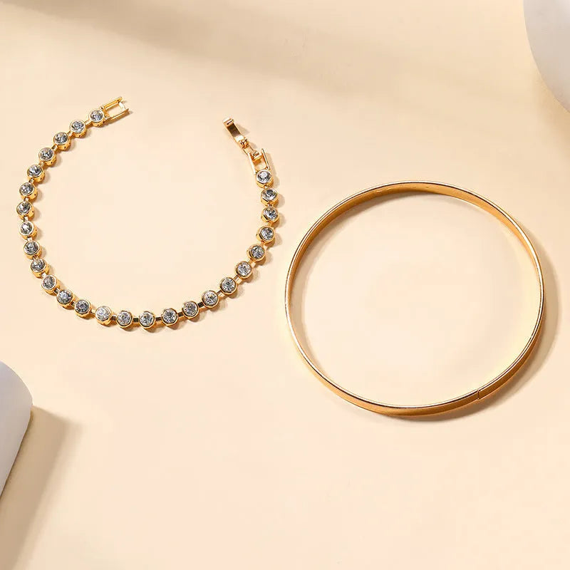 Gold and silver electroplated zinc alloy charm bracelet set with drop, geometric and water droplet details