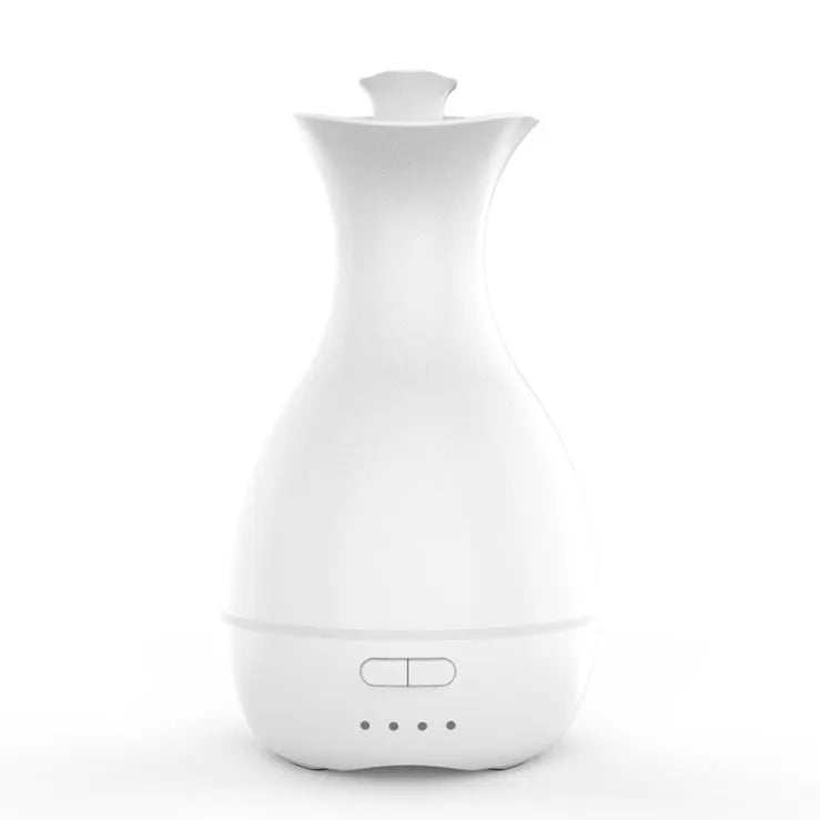 White or pink ceramic ultrasonic air humidifier and essential oil diffuser with colourful night light, 200ml capacity.