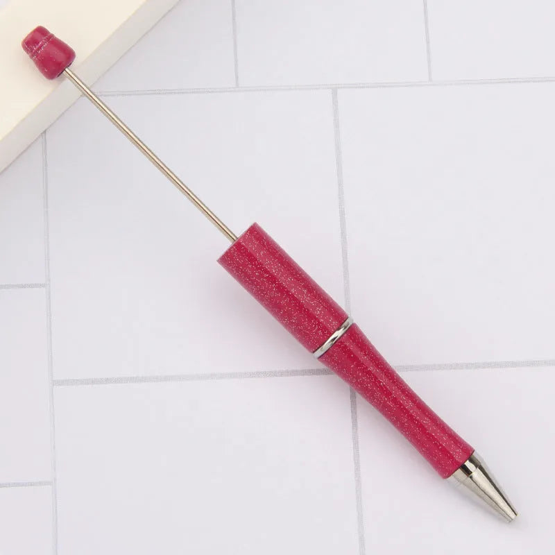 Ballpoint pen with colourful spinning plastic beads on barrel, shown in a gradient purple finish.