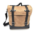 Motorcycle side pannier bag in black made from waterproof canvas with cowhide trim.