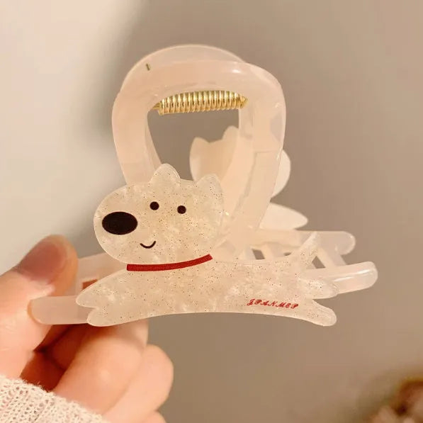 Beige and brown cartoon puppy hair grip barrettes on white background