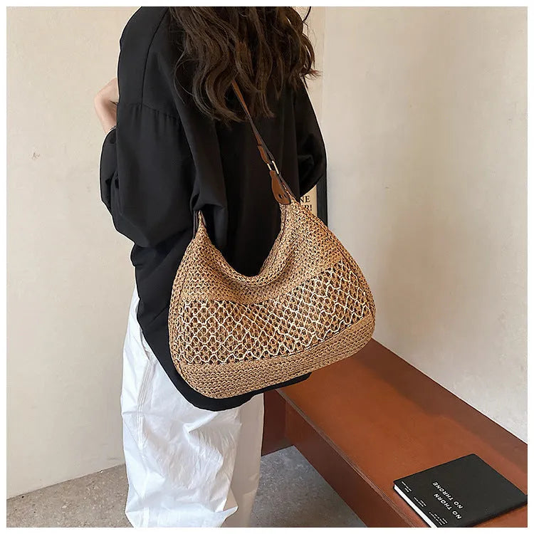Women's straw cross body bag in khaki colour showing horizontal square shape and woven texture