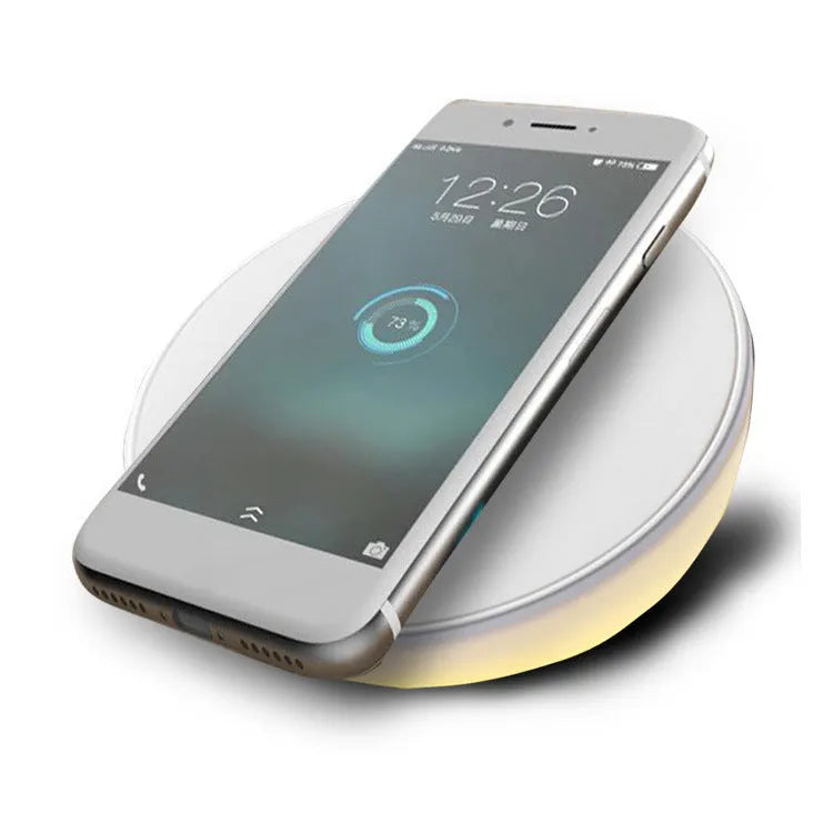 White wireless charging pad with digital clock display and control buttons