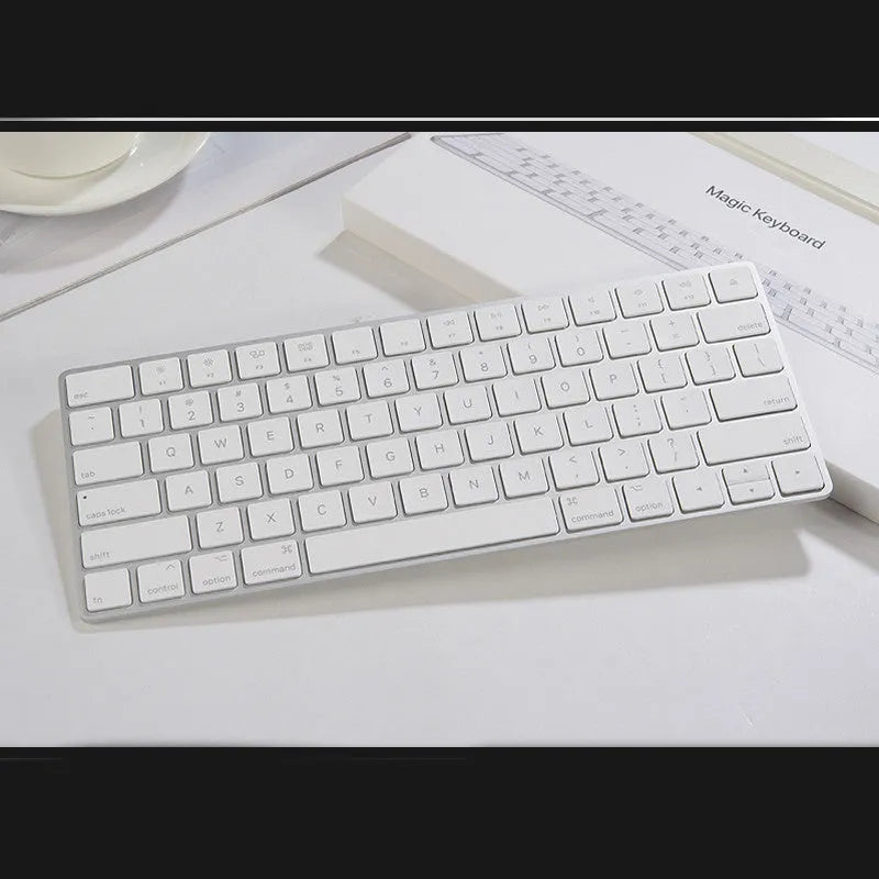 White Apple Bluetooth wireless keyboard with ultra-thin metal construction and multimedia function keys