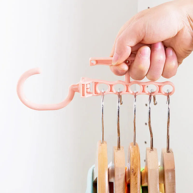 Rotating wardrobe hanger with five holes and handle in blue, green, or pink colour options