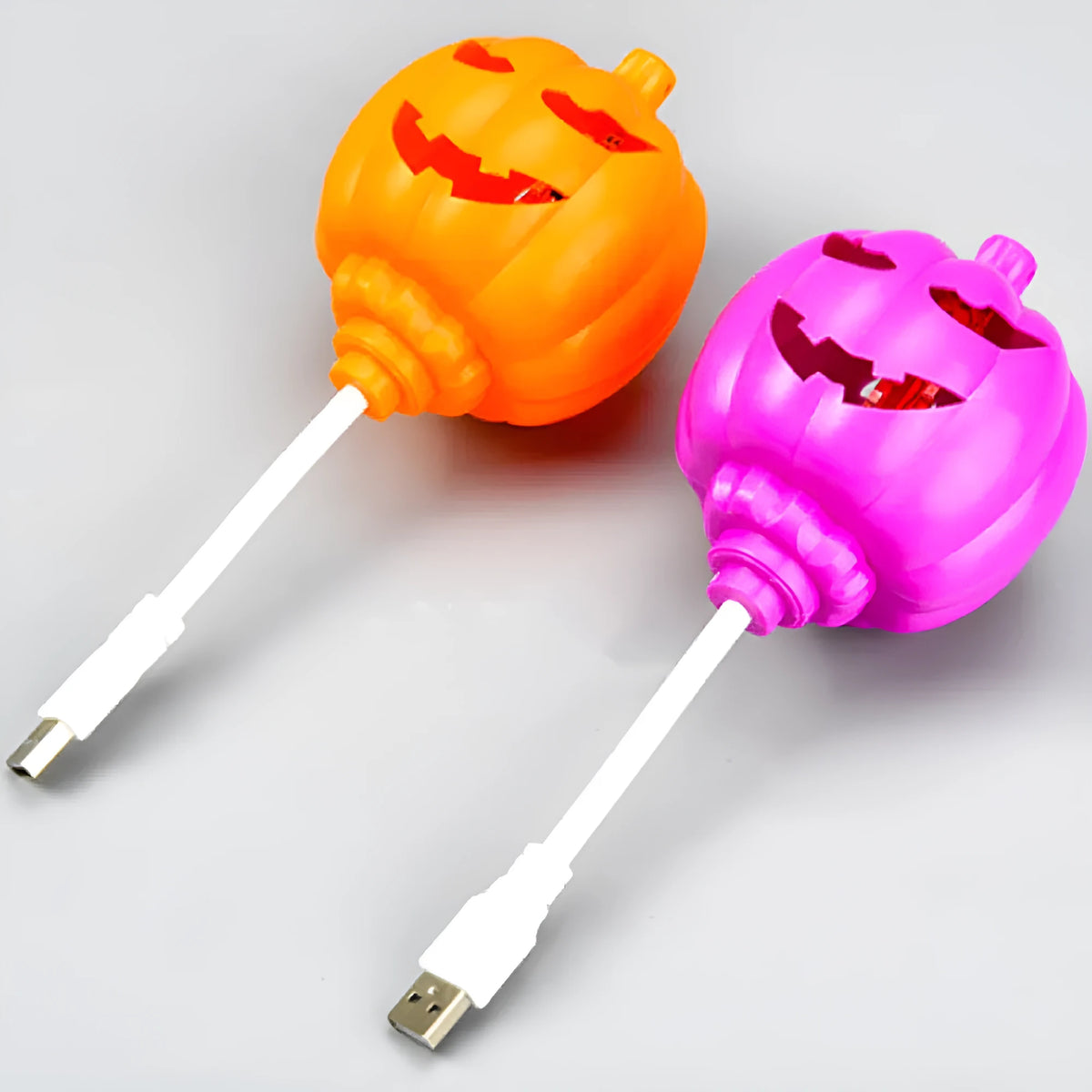 Plastic pumpkin lamp with USB charging cable in purple or yellow light colour