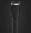 Black cordless electric hair clipper with nano ceramic cutter head and adjustable slider comb for men's grooming
