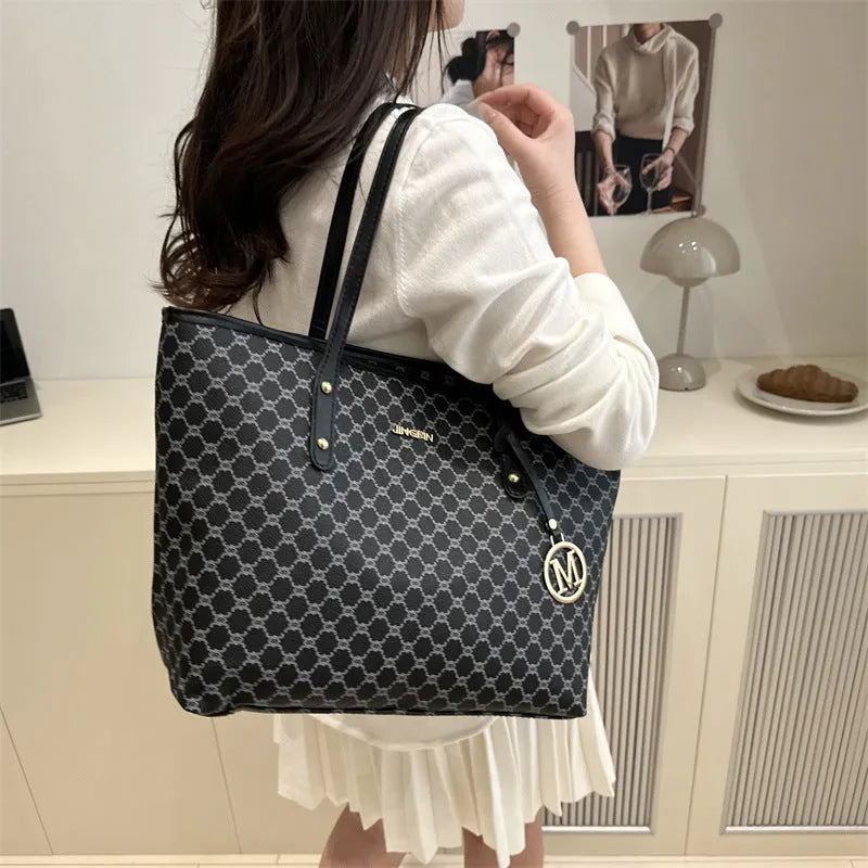 PU leather shoulder bag with sewing thread detail in black colour showing 42cm width and structured design