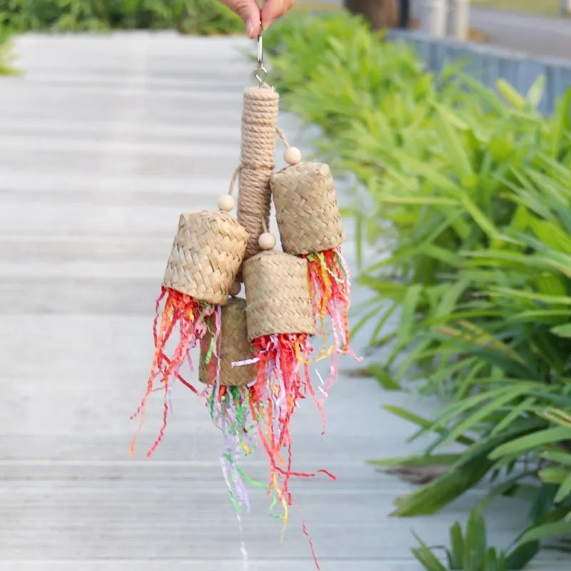 Parrot toy with wood and sisal construction containing colourful shredded paper, 15cm by 35cm