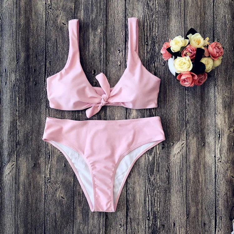 Women's solid colour bikini swimsuit set in polyester fabric, shown in black, pink, red, white, or wine red.