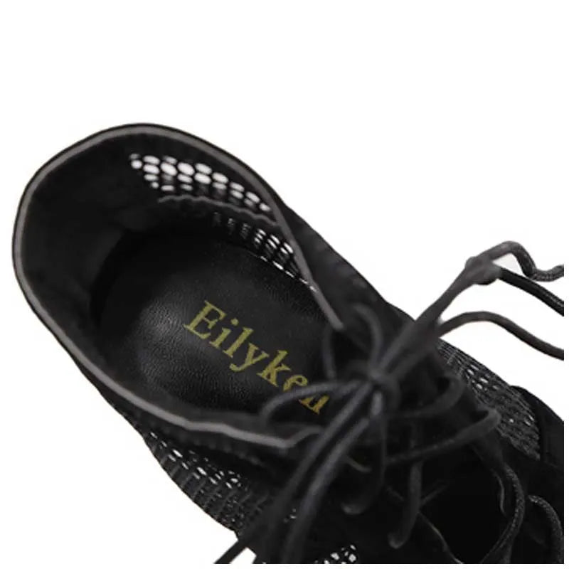 Black suede women's lace-up high heel shoes showing ankle strap and 11.5 cm heel.