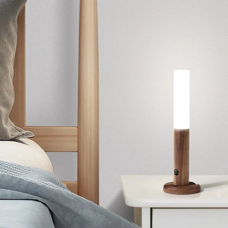 Smart sensor LED desk lamp in solid wood and acrylic on a desk, showing compact size and modern design.