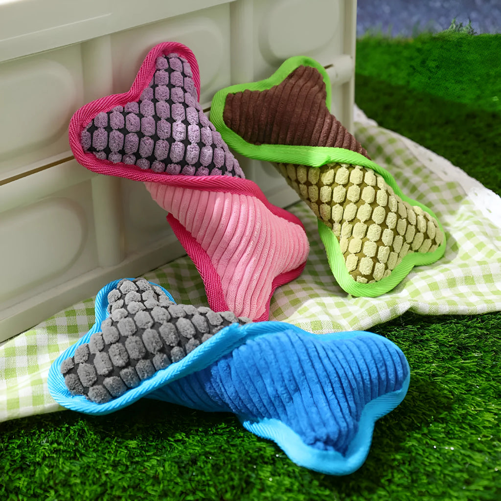 Blue dog toy with a squeaker bone, showing soft corn fleece lining and bite-resistant texture.