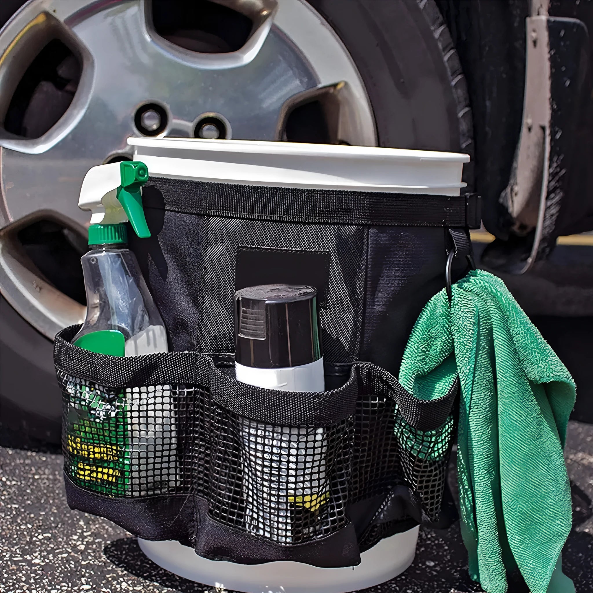 Black cylindrical polyester storage bag mounted on 5 gallon barrel for car washing and fishing gear organisation
