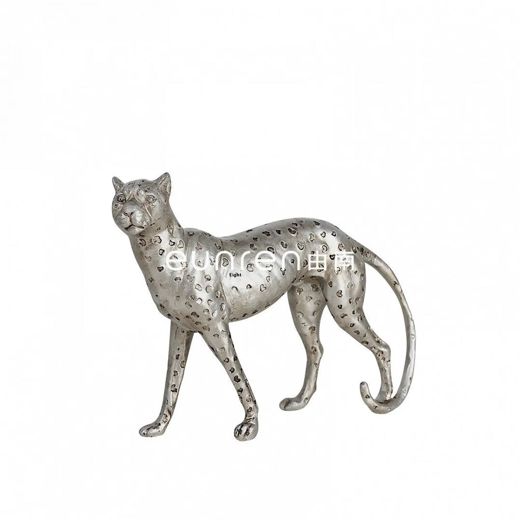Modern resin leopard figurine ornament in American Leopard colour on a shelf.