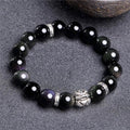 Silver 999 obsidian bracelet with lucky colour eye pattern showing male 12mm and female 10mm sizing options