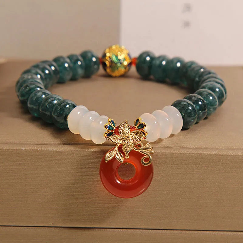 Blue water jade and red agate stone bracelet with peace buckle closure on crystal band