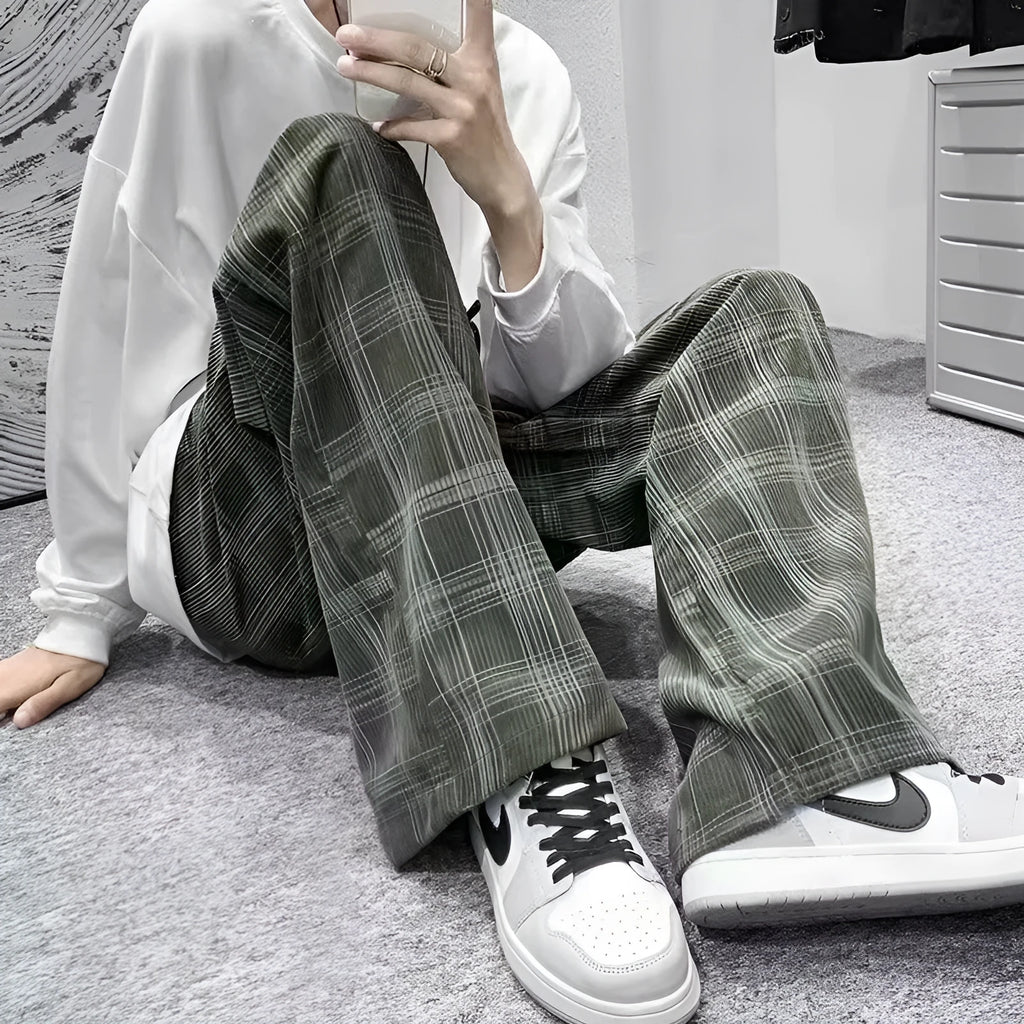 Man wearing black plaid retro loose-fit straight-leg casual trousers.