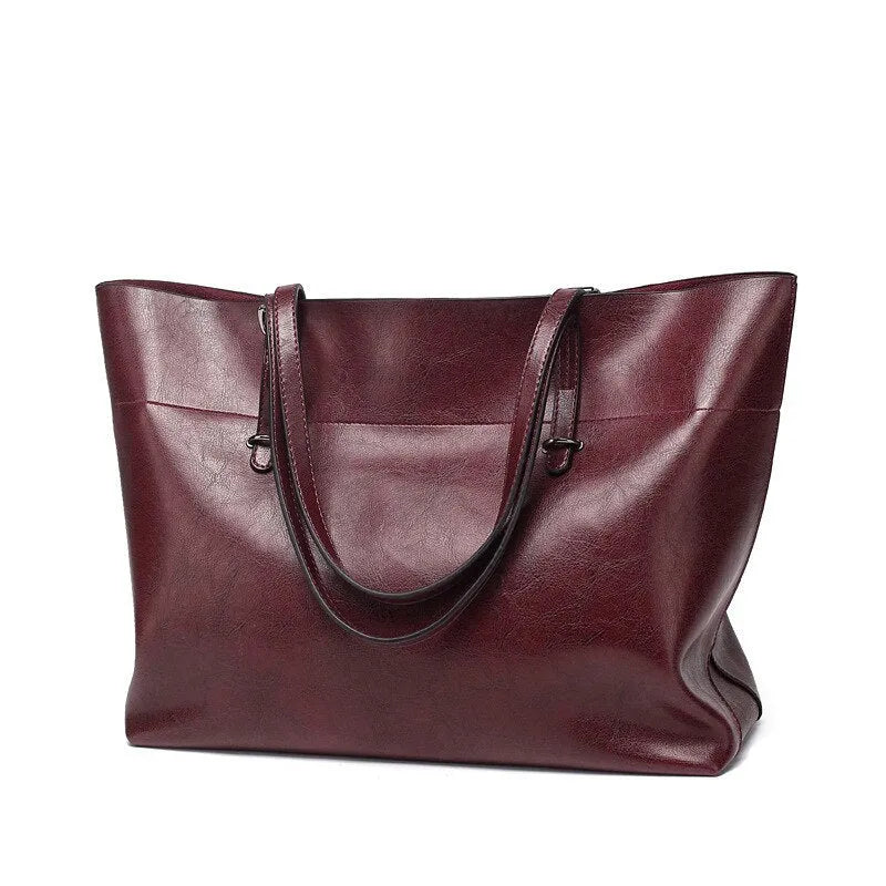 Waxed cowhide leather handbag showing horizontal cross-section opening and internal compartments