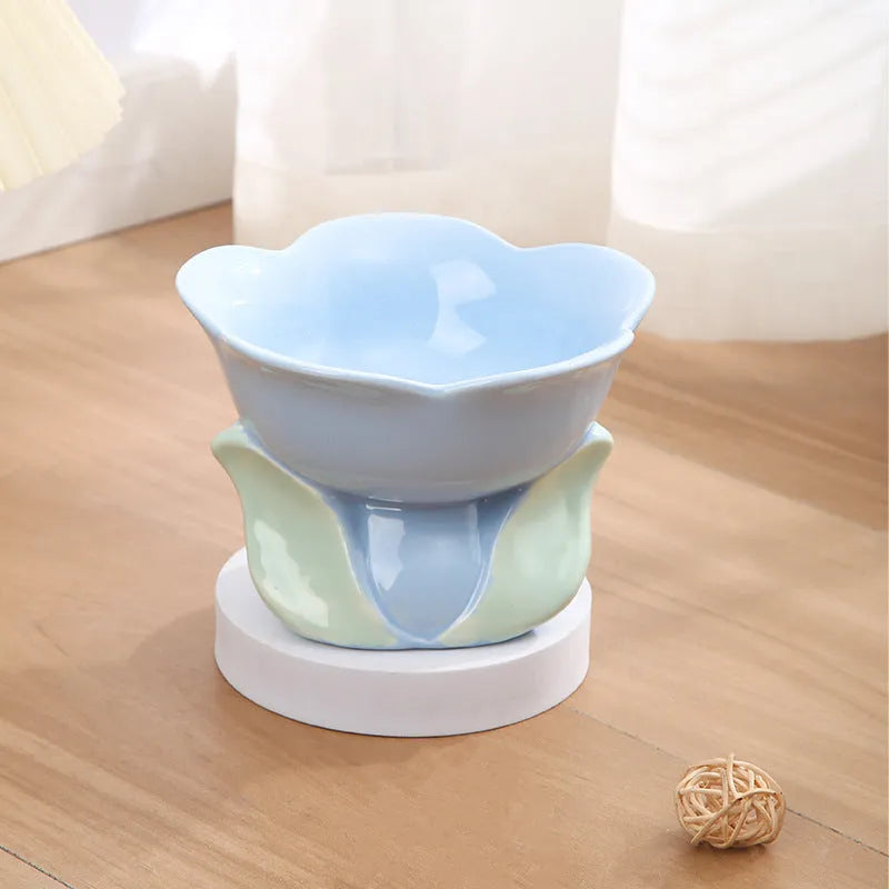 Blue ceramic elevated pet bowl with floral pattern and non-slip base for cats and small dogs.