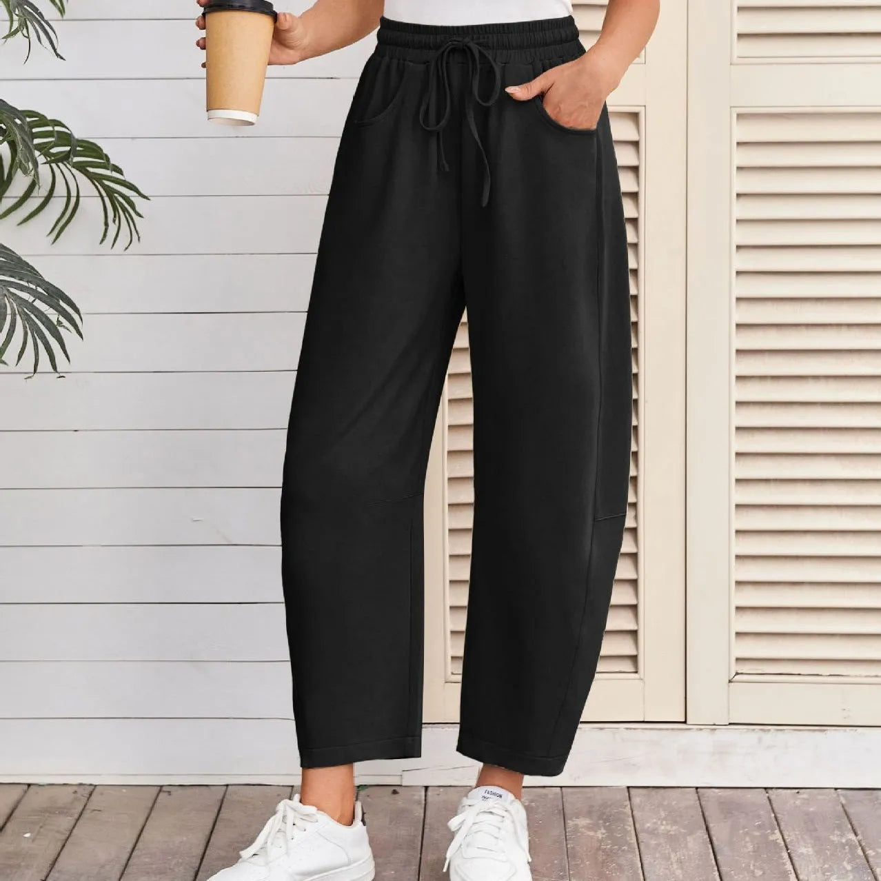 Loose cropped sweatpants with drawstring elastic waist in street fashion styling