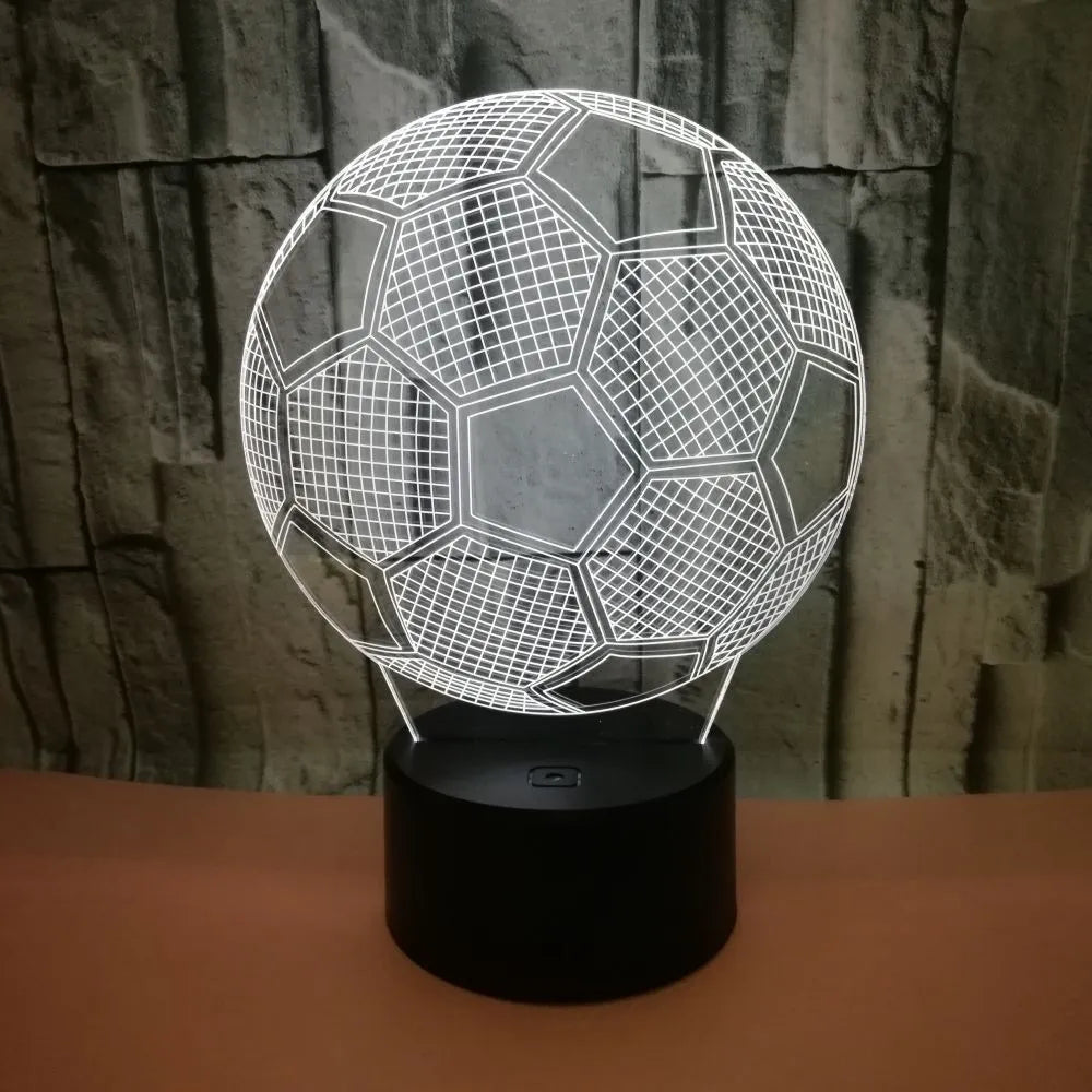 3D football-shaped acrylic night light displaying blue LED colour on a black ABS base.