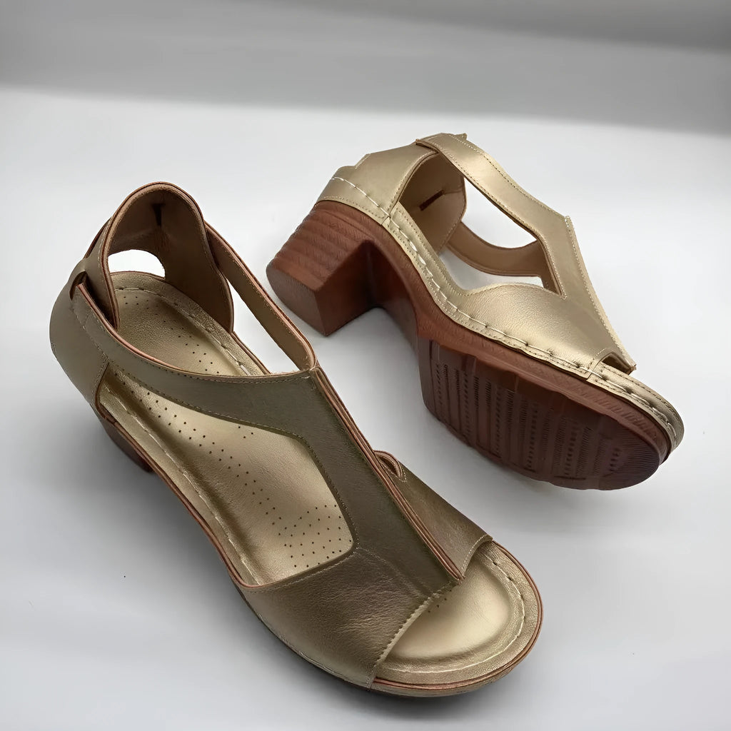 Women's peep toe wedge sandals with Roman-style buckle on a low heel.