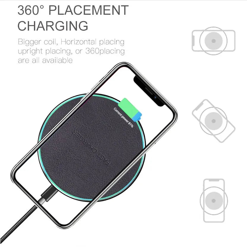 Black Qi wireless charging pad for iPhone 11 on a wooden desk