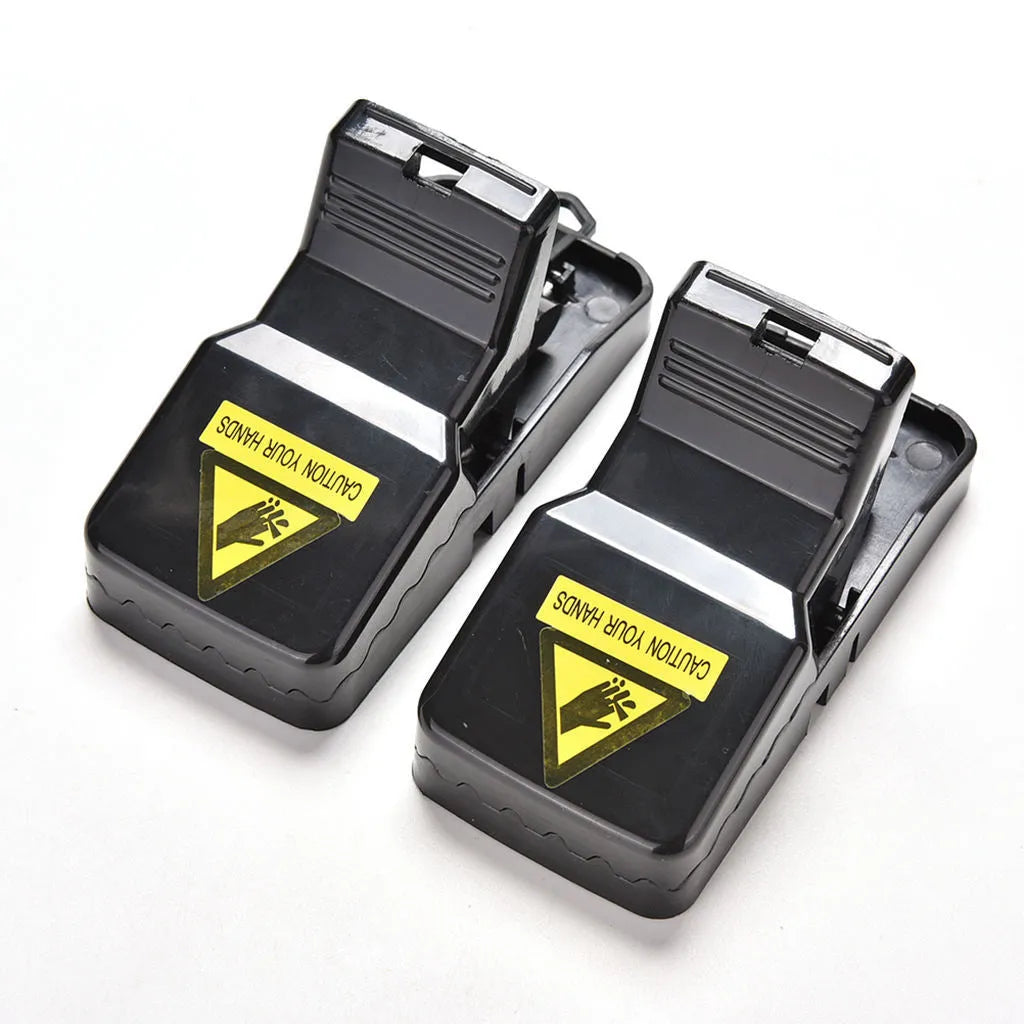 Six black snapping mousetraps showing PC+ABS alloy plastic construction and biting mechanism