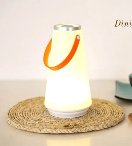 White rechargeable LED bedside lamp with square base measuring 12cm, showing warm white illumination from six LED beads