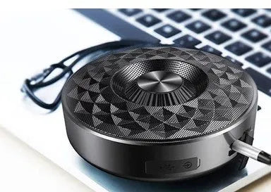 Compact black Bluetooth speaker showing front grill and controls.
