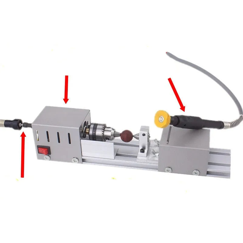 Silver metal mini manual woodworking lathe with carving knives on a workbench