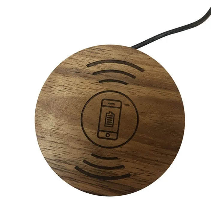 Black round 60mm wireless charging pad for embedded installation in desks and furniture.
