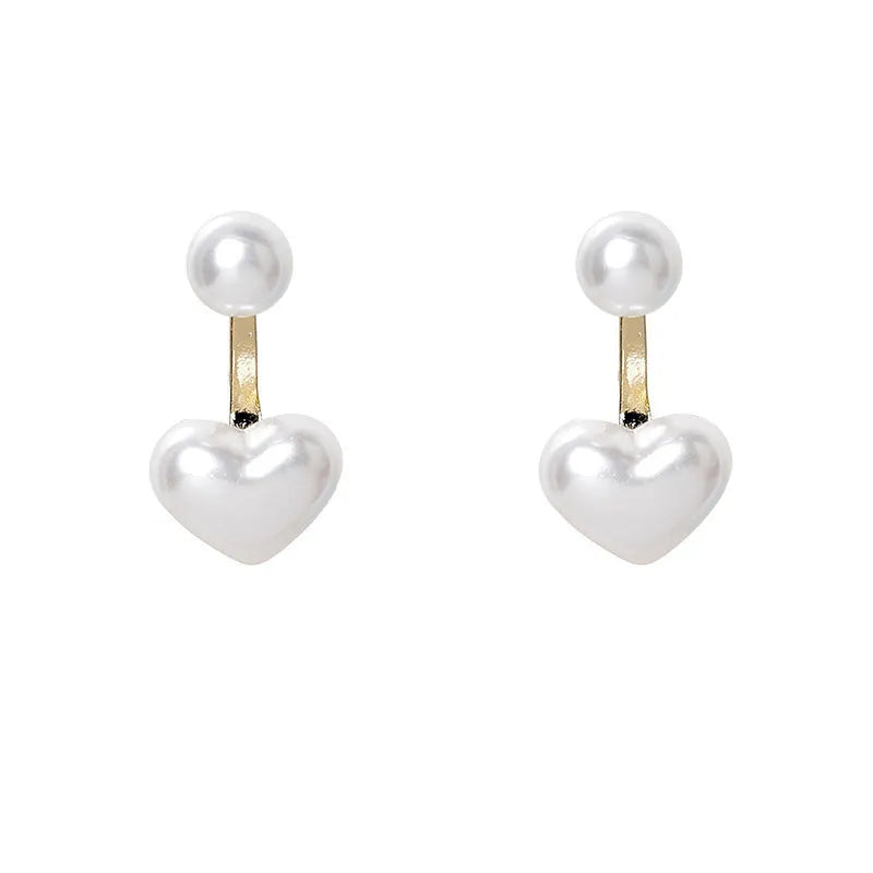 Women's silver-toned heart-shaped stud earrings with central gemstone inlay on a white background.