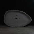 Handmade purple clay floor-standing flower pot showing texture and form, suitable for large indoor plants.