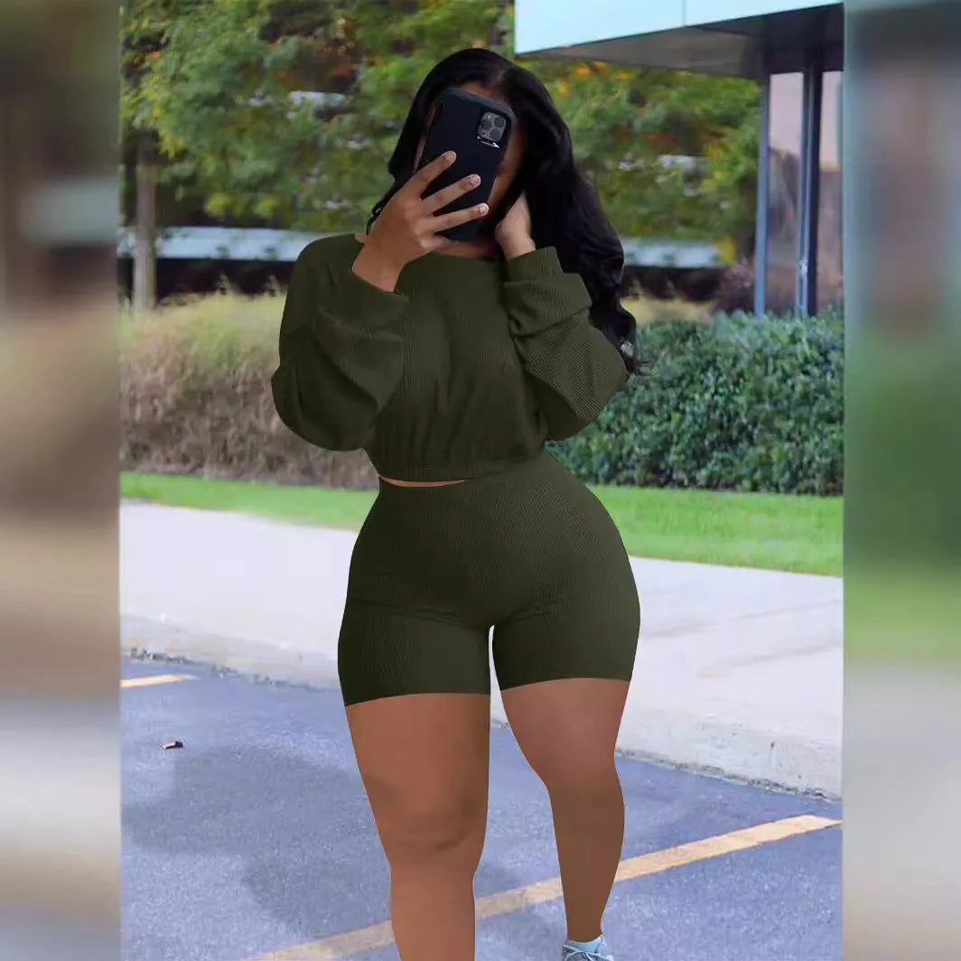 Women's solid colour off-the-shoulder long sleeve top and matching shorts two-piece set.