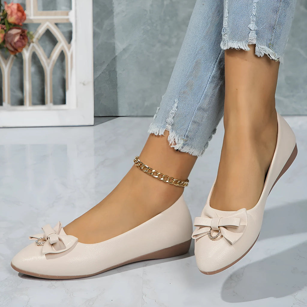 Women's beige casual flat slip-on shoes with a bowknot and shallow mouth design on a rubber sole.