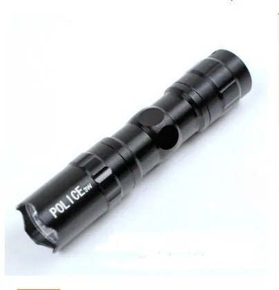 Black aluminium mini LED flashlight showing compact size next to a AA battery for scale.