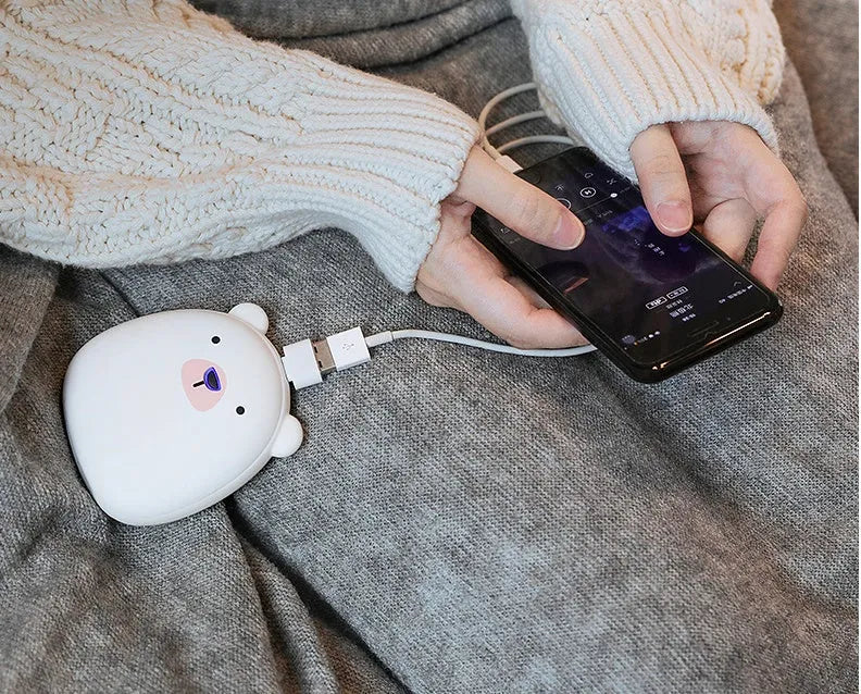 Cute cartoon penguin polar bear design USB rechargeable hand warmer and power bank unit.