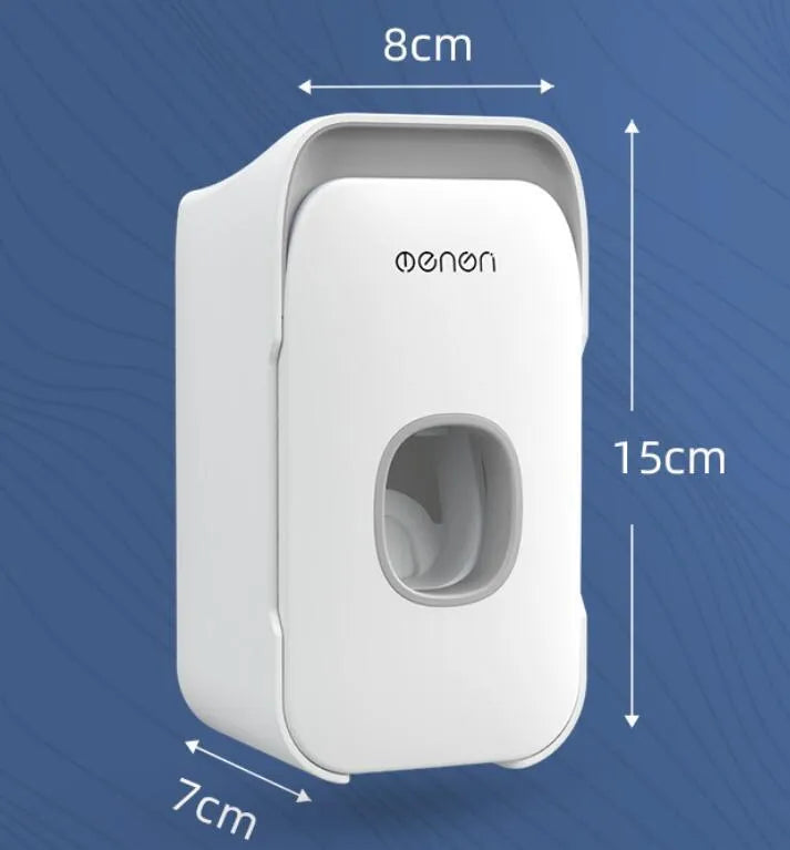 A blue automatic toothpaste dispenser mounted on a bathroom wall with a soft-touch button.