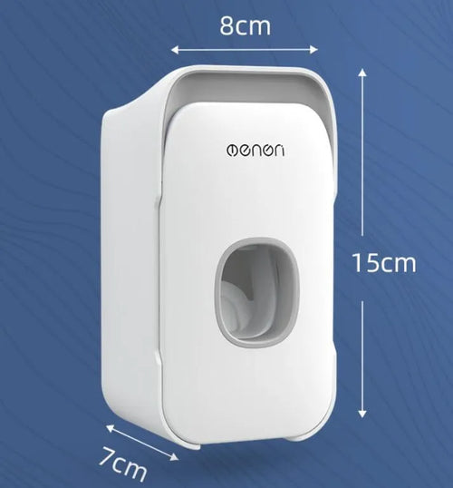 A blue automatic toothpaste dispenser mounted on a bathroom wall with a soft-touch button.