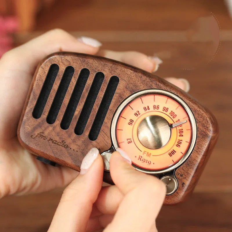 Retro wooden mini Bluetooth speaker in cherry wood finish showing front grille and wooden casing