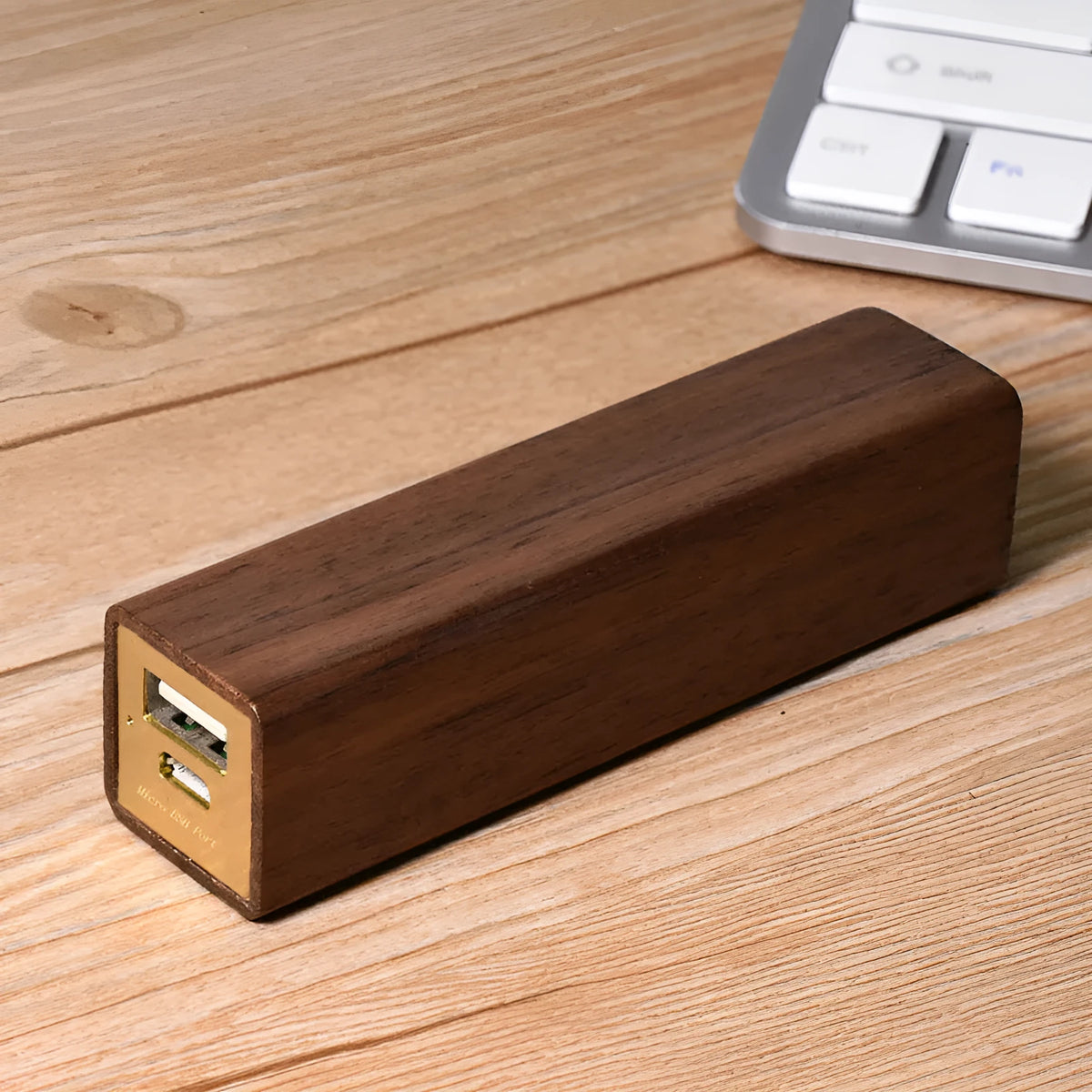 Brown walnut wood portable power bank with USB port showing compact rectangular design.