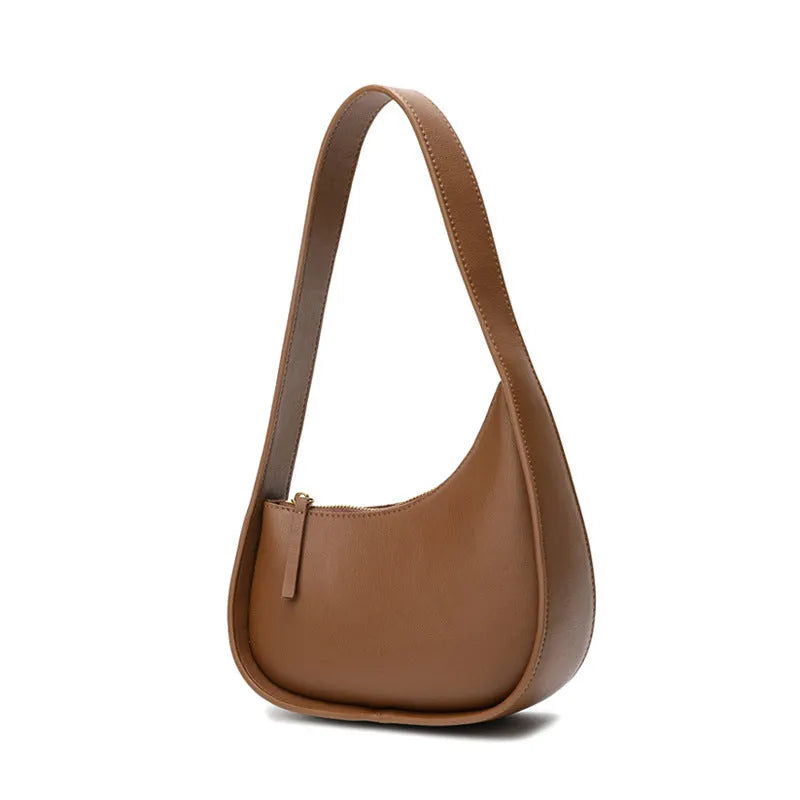 Small half moon leather ladies shoulder bag with wide strap in caramel colour