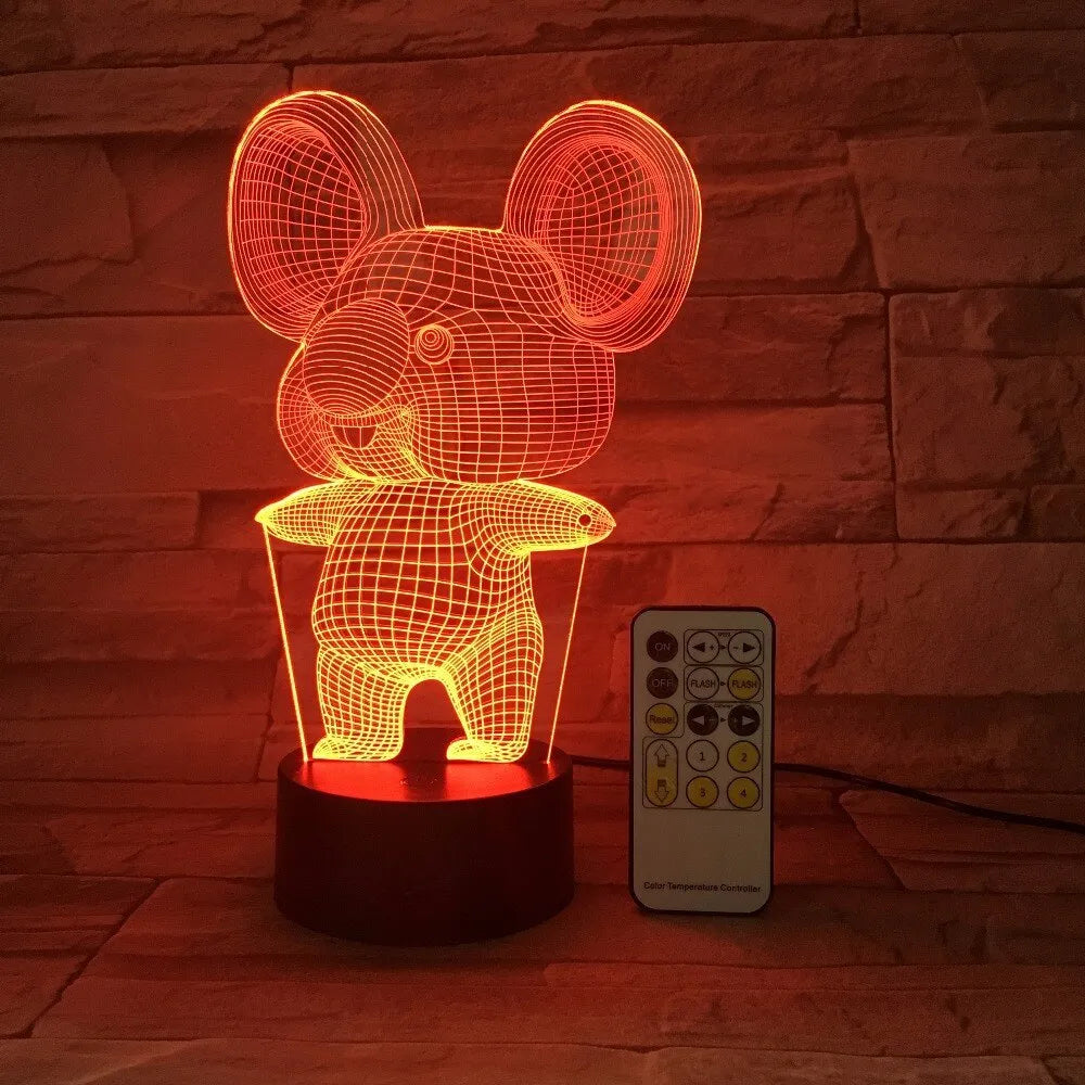 Black koala-shaped LED night light with remote control on a white surface