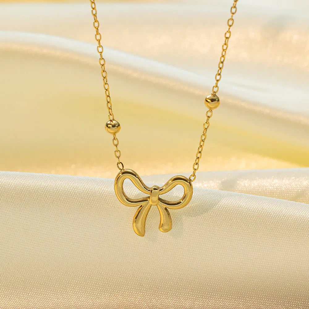 Gold bow necklace on cross chain with adjustable 41-50cm length